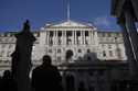 A man is silhouetted in front of the Bank of England in London, Thursday, February 6, 2025 which is…