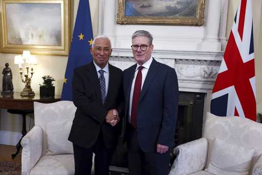 Britain's Prime Minister Keir Starmer, right, shakes hands with President of the European Council A…