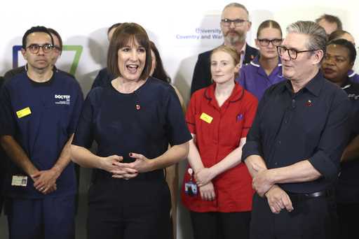 Britain's Prime Minister Keir Starmer and Chancellor Rachel Reeves speak with members of staff, dur…