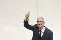 Apple CEO Tim Cook gestures as he accompanies Britain's King Charles III during a visit at Apple's …