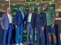 Former Milwaukee Bucks player Junior Bridgeman, center, stands with, from left, co-owner Jimmy Hasl…