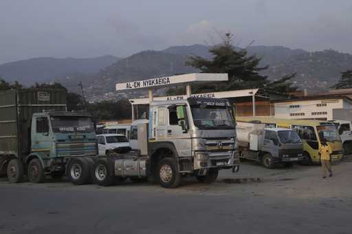 Parked vehicles and trucks are seen at a gas station as it runs without fuel in Bujumbura, Burundi,…