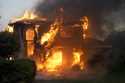 A fire burns a house in the Mountain fire, Wednesday, November 6, 2024, in Camarillo, Calif