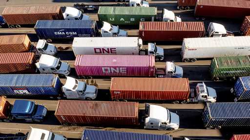 Trucks line up to enter a Port of Oakland shipping terminal on November 10, 2021, in Oakland, Calif…