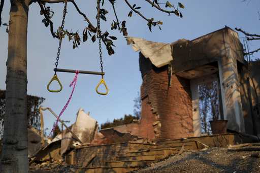 A swing hangs from a tree in front of a fire-damaged residence in the aftermath of the Palisades Fi…