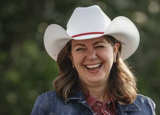 File - Alberta Premier Danielle Smith wears a cowboy hat during the Calgary Stampede parade in Calg…