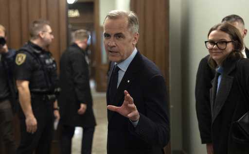 Canada Liberal leader Mark Carney speaks briefly with media before making his way to caucus meeting…