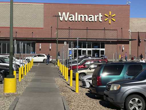 Shoppers head into and out of a Walmart store, February 7, 2025, in Englewood, Colo