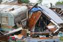 File - A person stands outside of a damaged home after a tornado hit May 13, 2023, in the unincorpo…