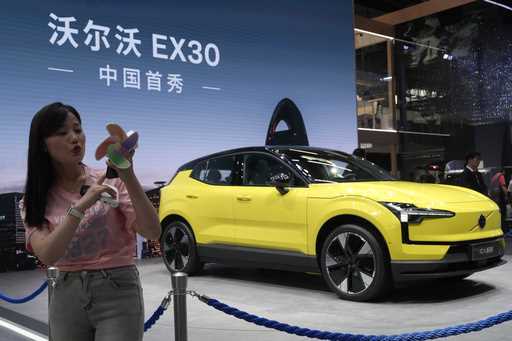 A live streamer works near the Volvo EX30 fully electric small SUV unveiled during Auto China 2024 …