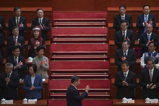 Chinese President Xi Jinping, center, arrives for the opening session of the National People's Cong…