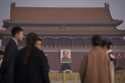 Journalists wait for the arrival of delegates at Tiananmen Square before the closing session of the…