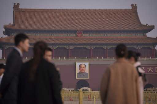 Journalists wait for the arrival of delegates at Tiananmen Square before the closing session of the…