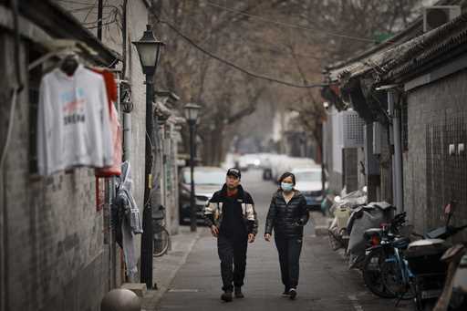 Local walk along an alley way in Hutong area in Beijing, China, Thursday, March 13, 2025