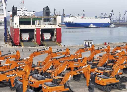 Engineering vehicles for export wait for transportation from a port in Yantai in eastern China's Sh…