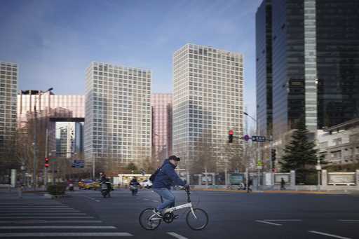 A man cycles pass a traffic junction with the office buildings around the Central Business District…