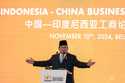 Indonesian President Prabowo Subianto gestures as he delivers a speech on stage during the Indonesi…