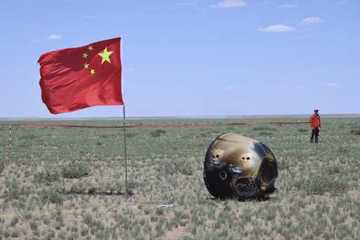 In this photo released by Xinhua News Agency, the return capsule of the Chang'e 6 probe is seen in …