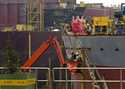 Workers construct the hull of a vessel at the STX shipbuilding plant on Changxing Island, on the ou…