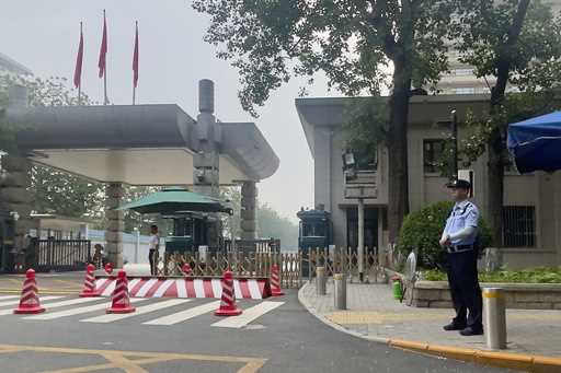 Chinese security personnel guard the entrance to the Jingxi Hotel where the Communist Party's 205-m…