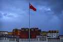 FILE- The Chinese flag flies at a plaza near the Potala Palace in Lhasa in western China's Tibet Au…