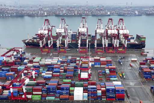 Cranes and transporters work at an automated container port in Qingdao in eastern China's Shandong …