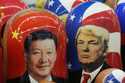 Traditional Russian wooden dolls called Matryoshka depicting China's President Xi Jinping, left, an…