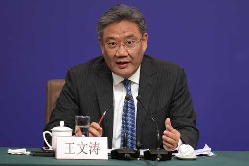 Chinese Commerce Minister Wang Wentao speaks at a press conference on the sideline of the National …