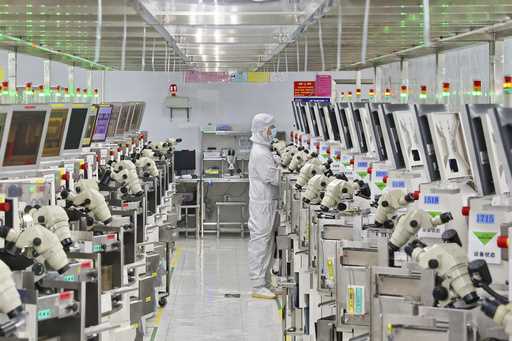 A man works at a manufacturer of Integrated Chip encapsulation in Nantong in eastern China's Jiangs…