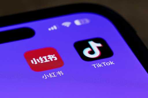 Icons for the smartphone apps Xiaohongshu and TikTok are seen on a smartphone screen in Beijing, Tu…