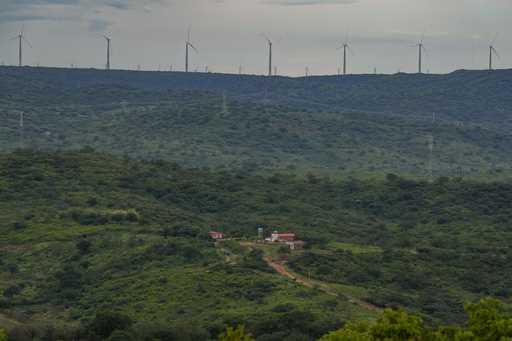 Wind turbines are visible in the distance of Sumidouro, Piaui state, Brazil, Wednesday, March 13, 2…