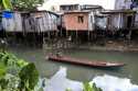 A boat goes down a tributary of the Tucunduba River in Belem, Brazil, Sept