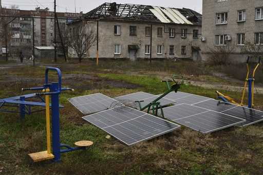 Solar panels sit in the yard of an apartment building in Lyman, Donetsk region, Ukraine, November 2…