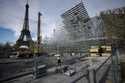 Workers build the stands for the upcoming Olympic Games on the Champ-de-Mars just beside the Eiffel…