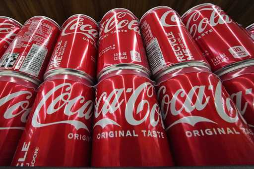 Cans of Coca-Cola are on display at a grocery market in Uniontown, Pa, April 24, 2022