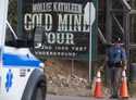 A police officer moves a barrier for an emergency vehicle, October 9, 2024, at Mollie Kathleen Gold…