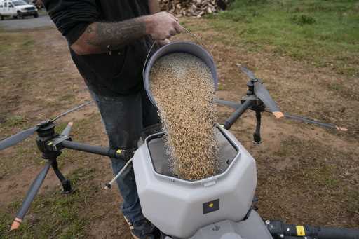 Russell Hedrick prepares a DJI drone to put crop cover on his farm, Tuesday, December 17, 2024, in …