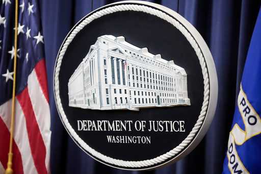 The logo for the Justice Department is seen before a news conference at the Department of Justice, …