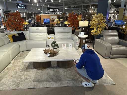 A shopper pauses at a display in a furniture store Sunday, June 2, 2024, in Englewood, Colo