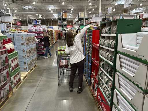 Shoppers reach for items on display in a Costco warehouse November 19, 2024, in Lone Tree, Colo