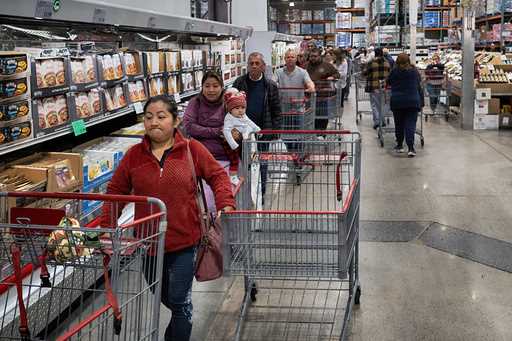 Customers wait in line for eggs at a Costco store in the Van Nuys section of Los Angeles on Wednesd…