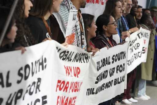 Activists participate in a demonstration for climate finance at the COP29 U