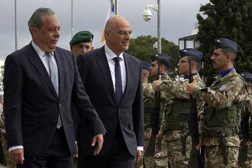 Cyprus' Minister of Defence Vasilis Palmas, left, and his Greek counterpart Nikos Dendias review a …