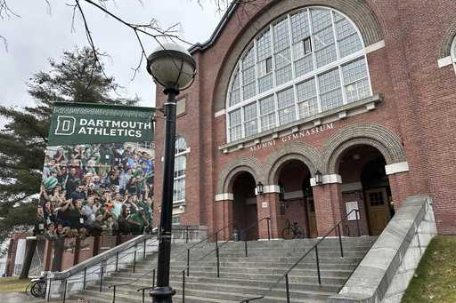 A Dartmouth Athletics banner hangs outside Alumni Gymnasium on the Dartmouth University campus in H…