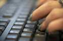 A woman types on a keyboard in New York, October 8, 2019