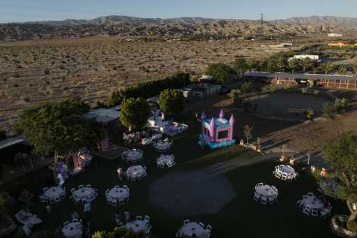This aerial view shows Carlos Ulloa's Rancho El Refugio date palm ranch decorated for a baptism cer…