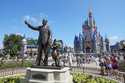 Guests pass a statue of Walt Disney and Mickey Mouse in the Magic Kingdom at Walt Disney World on J…