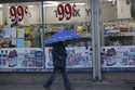 A pedestrian walks past a 99 Cents Only store under light rain in Los Angeles Wednesday, December 5…