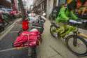 A food delivery worker rides down a sidewalk after a pickup from a restaurant in New York on Januar…