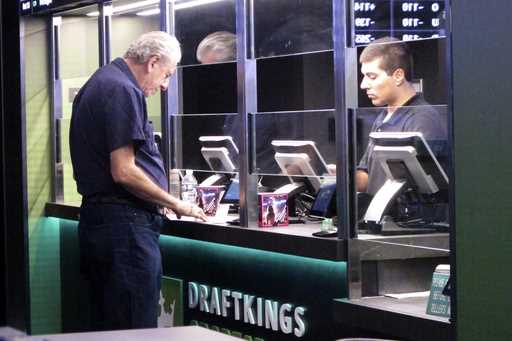 A man makes a sports bet at the DraftKings sports book in Atlantic City, N